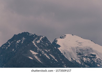 Mountain range under cloudy sky. Snowy peaks of mountains rocks