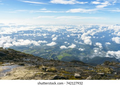 A mountain range view with clouds and blue sky. 