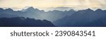 Mountain range with visible silhouettes through the morning fog. Traveling along the mountains, freedom and active lifestyle concept. Vibrant photo wallpape. Natural background. Panorama  Carpathian