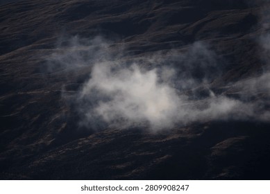 Mountain ranges interwoven with thin mist.