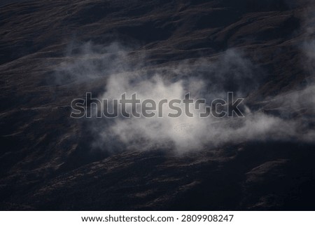 Mountain ranges interwoven with thin mist.