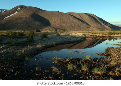 Mountain reflecting in water - early morning in tundra of Chukotka, Far East Russia