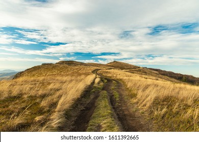 Mountain Ridge Highland Dry Grass Meadow Dirt Trail Route To Horizon Board Scenic Landscape Autumn Background View, Copy Space 