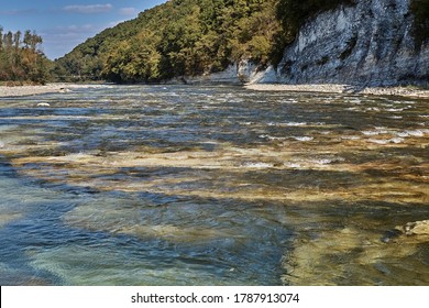mountain river between cliffs under sun