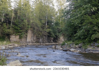 mountain river between rocks and trees