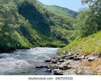 Mountain River In The Forest In Kamchatka In Summer.