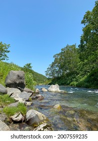 Mountain River In The Forest In Kamchatka In Summer.