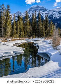 Mountain river in a snowy forest in winter. River reflection in winter mountain snow. Winter river in snowy mountains. River in winter snow scene - Shutterstock ID 2259808021