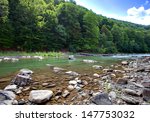 mountain river with stones and sky