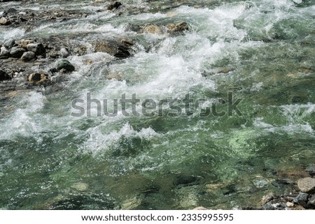 Mountain river stream water rush in rocky nature. Close up of river stream on stones. Mountain river. Selective focus.