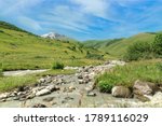 Mountain river valley path panoramic landscape in sunny day. Nature background
