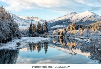 Mountain river valley in snowy winter. River valley in snowy mountains. Mountain river valley in snow. Winter snow river in mountains