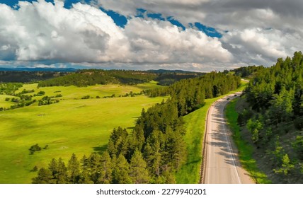 Mountain road aerial view through the woods in summer season. - Shutterstock ID 2279940201