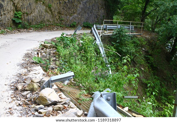 mountain road with broken fence\
after car accident, industrial transportation\
image