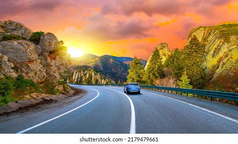 Mountain road landscape at colorful sunset. car driving on highway in summer. stunning highway scenery in europe. road scene in colorful nature. Nature landscape on beautiful highway. - Powered by Shutterstock