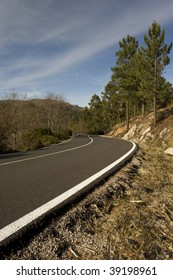 Mountain road with many curves, in blue sky background - Shutterstock ID 39198961