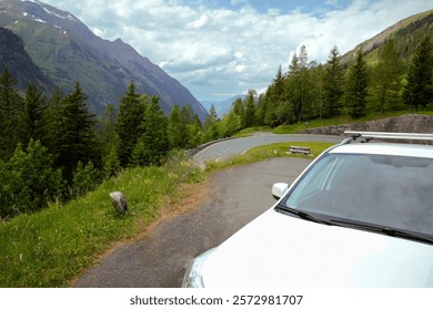 Mountain Road Scenic View with White Car and Alpine Landscape