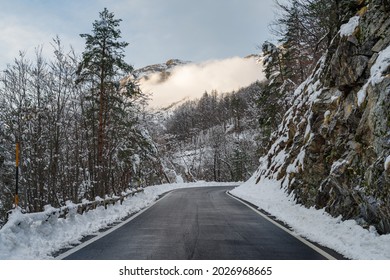 Mountain road and snow-covered forest in winter, Ligurian Alps, Italy - Shutterstock ID 2026968665