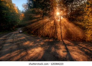 Mountain road sunrise with god rays