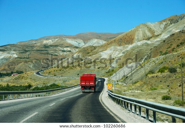 Mountain road  with\
truck and cars in\
Turkey.