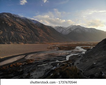 Mountain Road. White Peaks. Dangerous Cliffs. Pamir. Fast River. Rocks. Dangerous Road. Roof Of The World. Talikistan. Badakhshan.Traveling In The Mountains. Afganistan. Murgab.