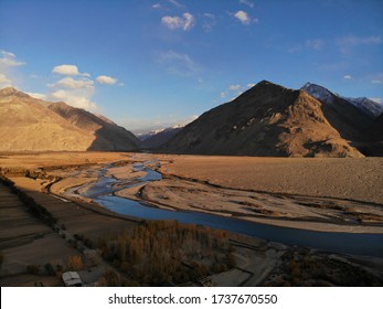 Mountain Road. White Peaks. Dangerous Cliffs. Pamir. Fast River. Rocks. Dangerous Road. Roof Of The World. Talikistan. Badakhshan.Traveling In The Mountains. Afganistan. Murgab.