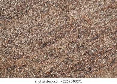 Mountain rock texture. Natural brown slate granite slab marble stone ceramic seamless tile rough surface background. Architecture grunge modern abstract style element. Close-up, copy space
