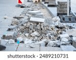 A mountain of rubble and the remains of old paving stones at a construction site