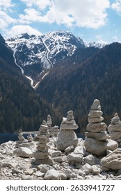Mountain scenery high in the Alps by the Antholzer lake . Stacked rock piles lead the view to the high peaks at the background.