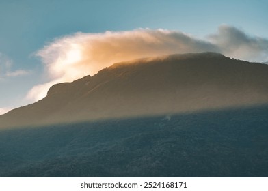 mountain silhouette at dawn with sun rays coming out through the clouds a new day a new purpose and opportunity in a beautiful panoramic Andean landscape with deep and dense forests - Powered by Shutterstock