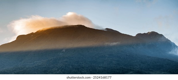 mountain silhouette at dawn with sun rays coming out through the clouds a new day a new purpose and opportunity in a beautiful panoramic Andean landscape with deep and dense forests - Powered by Shutterstock