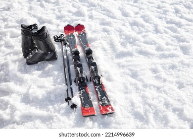 Mountain skis, ski boots and poles on bright alpine snow. Winter holidays.  Extreme sport. Vacation, travel content. Copy space - Shutterstock ID 2214996639