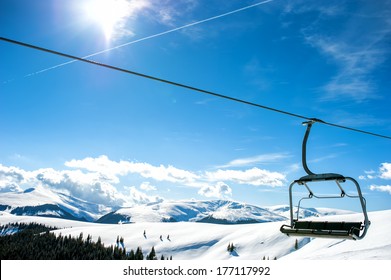 Mountain slopes with chairlift on a winter sunny day - Powered by Shutterstock