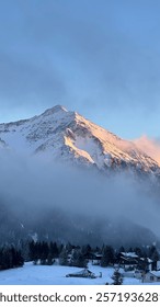 Mountain in snow with clouds 