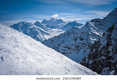 Mountain snow slopes in winter. Snowy mountain scene. Mountain snow peaks. Snow covered mountain peaks - Powered by Shutterstock