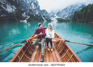 Mountain stories. Happy couple on a wanderlust vacation. Boyfriend and girlfriend spending time together at the lake. Storytelling concept about lifestyle and winter travels