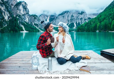 Mountain stories. Happy couple on a wanderlust vacation. Boyfriend and girlfriend spending time together at the lake. Storytelling concept about lifestyle and winter travels - Powered by Shutterstock