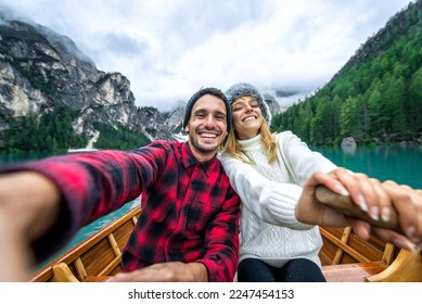 Mountain stories. Happy couple on a wanderlust vacation. Boyfriend and girlfriend spending time together at the lake. Storytelling concept about lifestyle and winter travels - Powered by Shutterstock