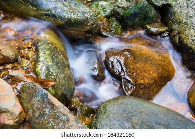 the mountain stream through rocks