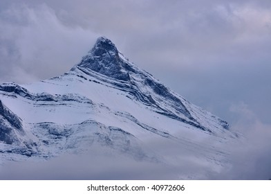 Mountain summit, shrouded in clouds, cold