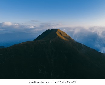 Mountain Summit Under Cloudy Sky