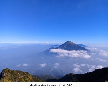 a mountain surrounded by clouds around it