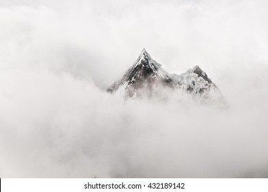 Mountain Top Surrounded By Clouds