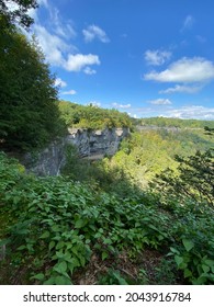 A mountain top view of a waterfall. 