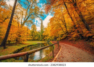 Mountain trail with calm lake, amazing autumn colors of leaves trees, sunny dream landscape. Beauty of nature concept background. Adventure hiking freedom stunning forest natural scene. Majestic view - Powered by Shutterstock