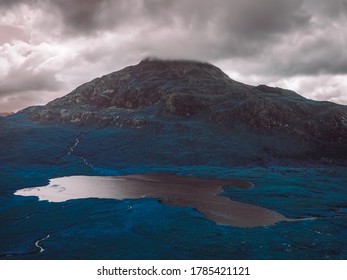  a mountain under cloudy sky 