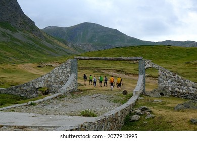 Mountain Valley With Stone Bridge Over River Around Village Dobërdol In Albania. Silhouette Of Hiking People. Albanian Alps, Peaks Of Balkans