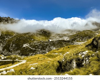 mountain valley under the clouds. lonely mountain hut. lush greenery. mountain landscape. in the clouds. nature background. Log pod Mangartom - Powered by Shutterstock