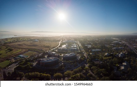 Mountain View, CA, USA - April 18 2017: Aerial Drone View Of Google Campus Called Googleplex Headquarters In Silicon Valley Rotate Left On A Early Morning As The Sunrays  On Solar Panels On Rooftop