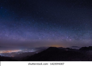 Mountain view morning at night of top hills and city around with soft fog under the stars in dark sky background, Monzone View Point Doi Ang Khang, Chiang Mai, northern of Thailand. - Powered by Shutterstock